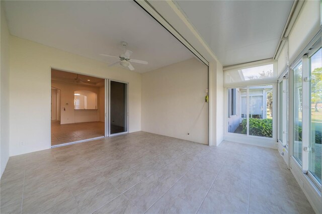 tiled empty room with ceiling fan