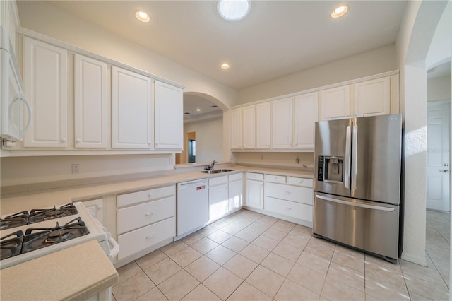 kitchen featuring white cabinetry, white appliances, sink, and light tile patterned floors