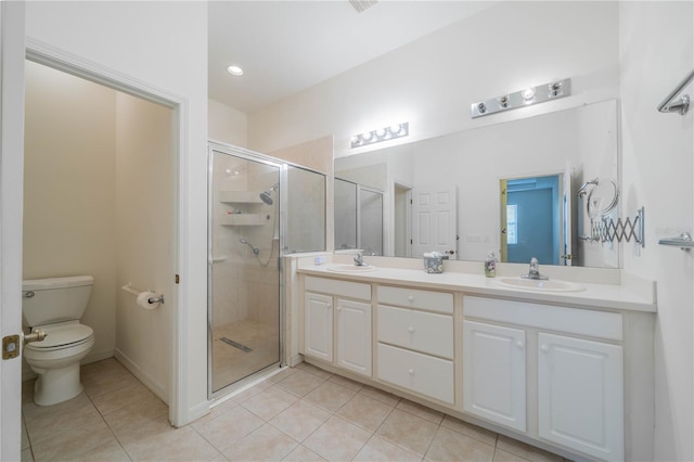 bathroom featuring vanity, tile patterned floors, toilet, and walk in shower