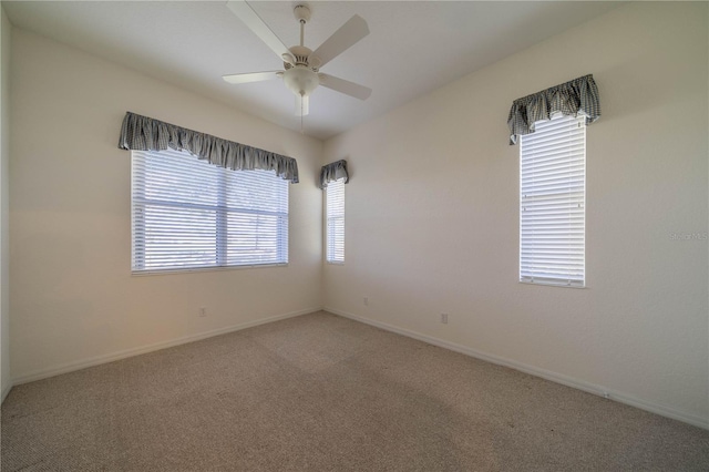 spare room featuring ceiling fan and carpet