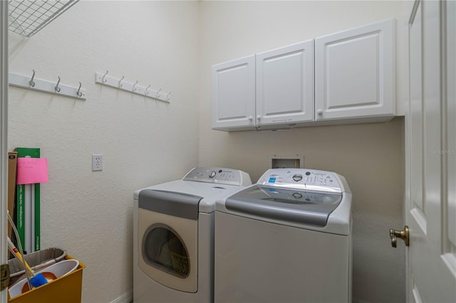 washroom with cabinets and independent washer and dryer