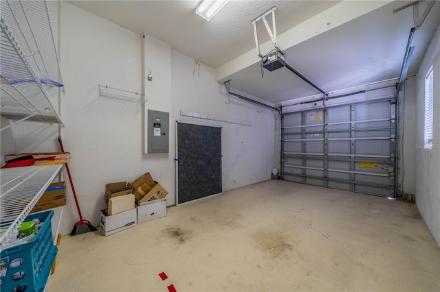 garage with a garage door opener and electric panel