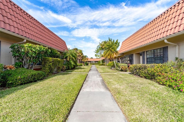 view of property's community with a lawn