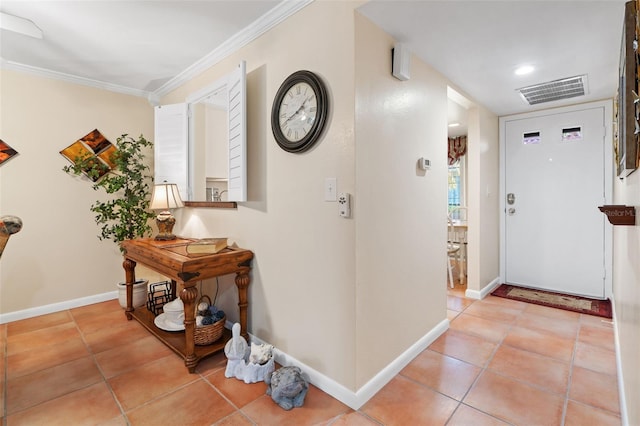 tiled entrance foyer with crown molding