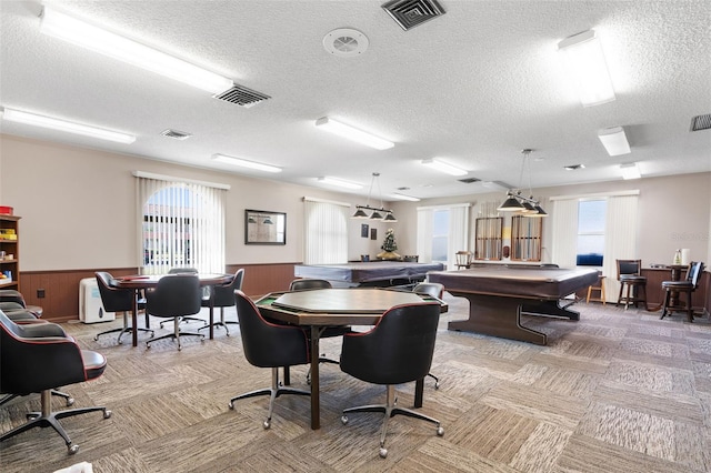 playroom featuring a textured ceiling, light colored carpet, wooden walls, and billiards