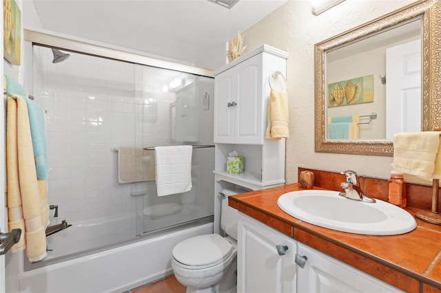 19029 US Highway 19 Unit 25D, Clearwater, FL 33764 - bathroom with bath / shower combo with glass door, vanity, and toilet