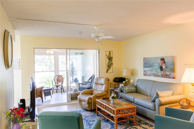 tiled living room featuring ceiling fan and a textured ceiling