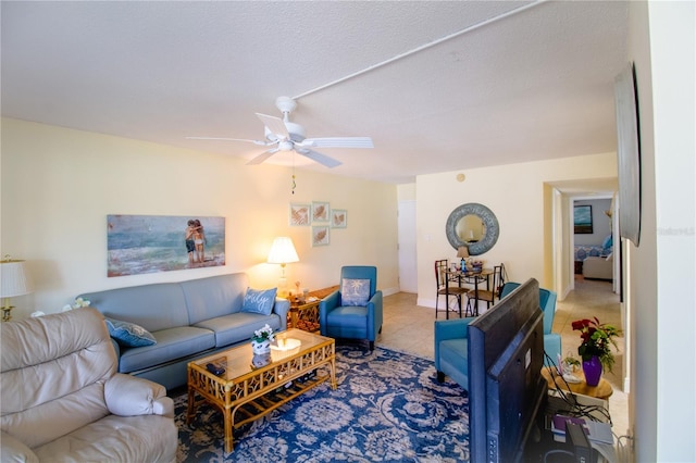 living room with a textured ceiling and ceiling fan