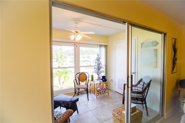 sunroom featuring ceiling fan