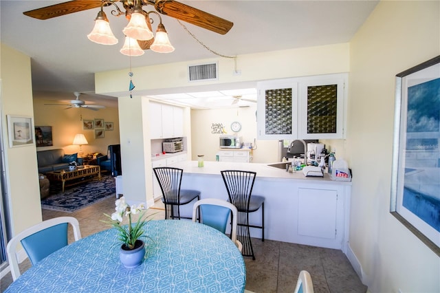 tiled dining room featuring a chandelier