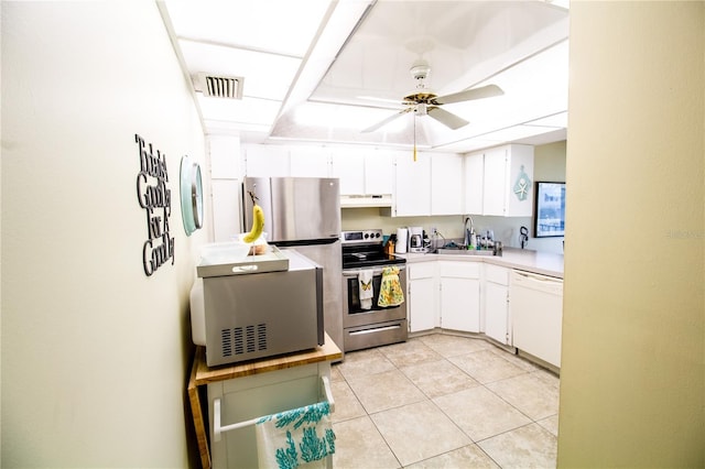 kitchen featuring sink, ceiling fan, light tile patterned floors, white cabinetry, and stainless steel appliances