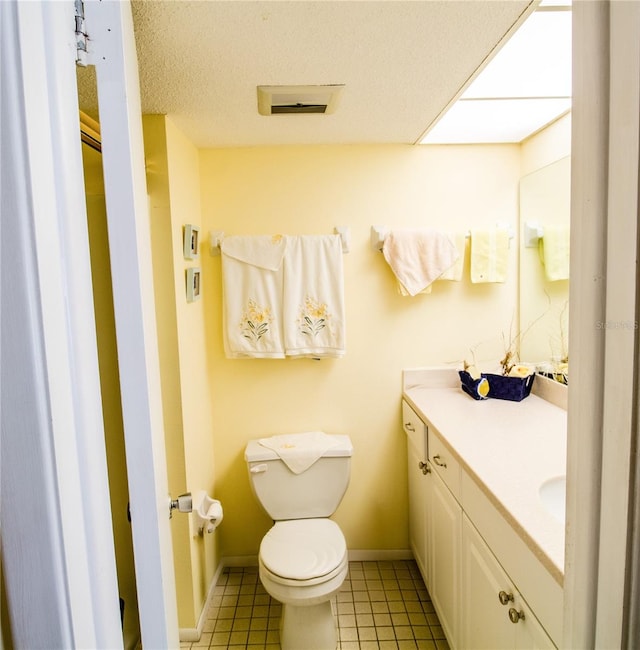 bathroom featuring tile patterned flooring, vanity, and toilet