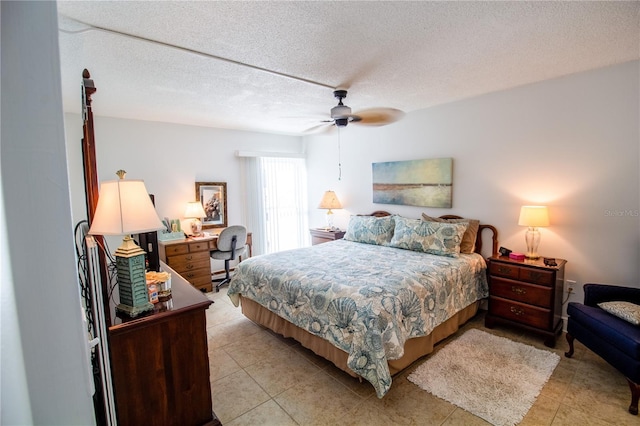 bedroom featuring a textured ceiling, ceiling fan, and light tile patterned flooring