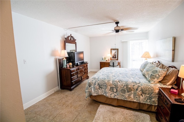 tiled bedroom featuring ceiling fan and a textured ceiling