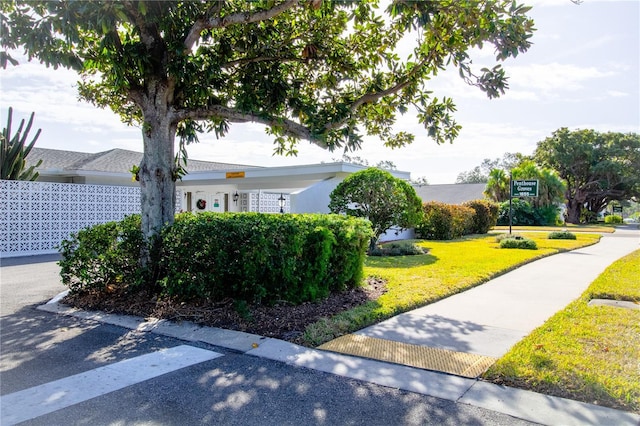 view of property exterior with a lawn