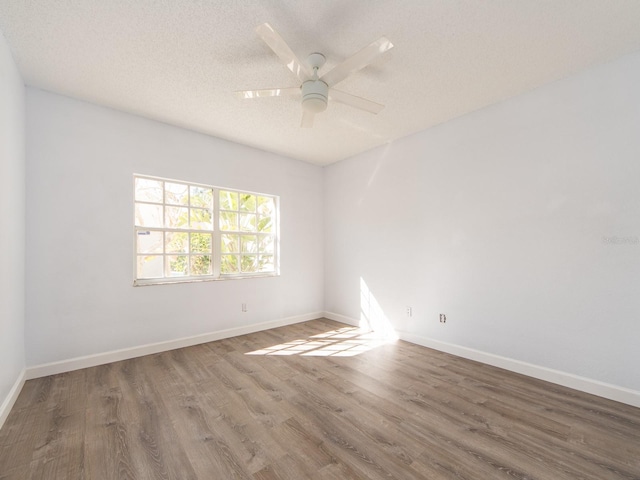 spare room featuring a textured ceiling, hardwood / wood-style flooring, and ceiling fan