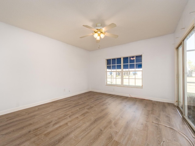 empty room featuring hardwood / wood-style flooring and ceiling fan