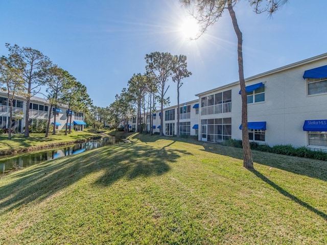 surrounding community featuring a yard and a water view