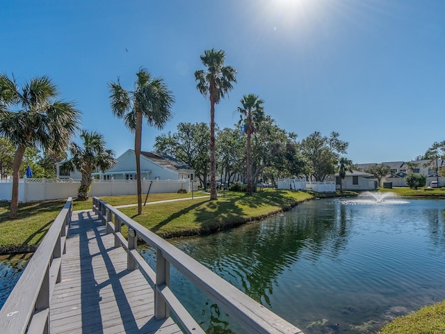 dock area featuring a yard and a water view