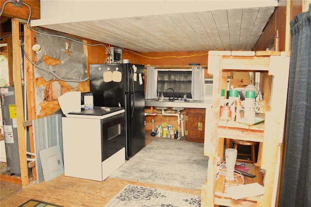 kitchen with sink, black fridge, electric water heater, white range with electric cooktop, and washer / clothes dryer