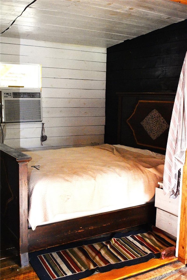 unfurnished bedroom featuring cooling unit and wooden walls