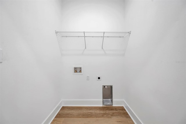 clothes washing area with washer hookup, electric dryer hookup, and hardwood / wood-style flooring