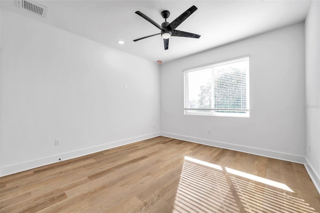 empty room with ceiling fan and light hardwood / wood-style flooring