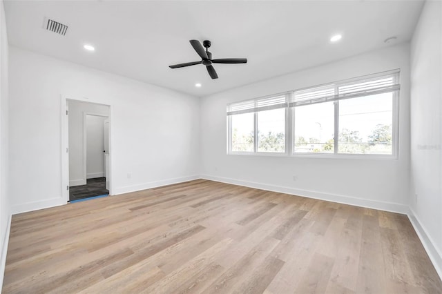 empty room with light hardwood / wood-style floors and ceiling fan