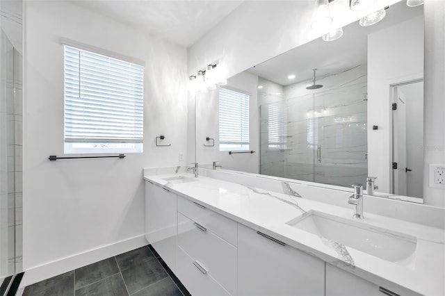 bathroom with tile patterned floors, a shower with shower door, and vanity