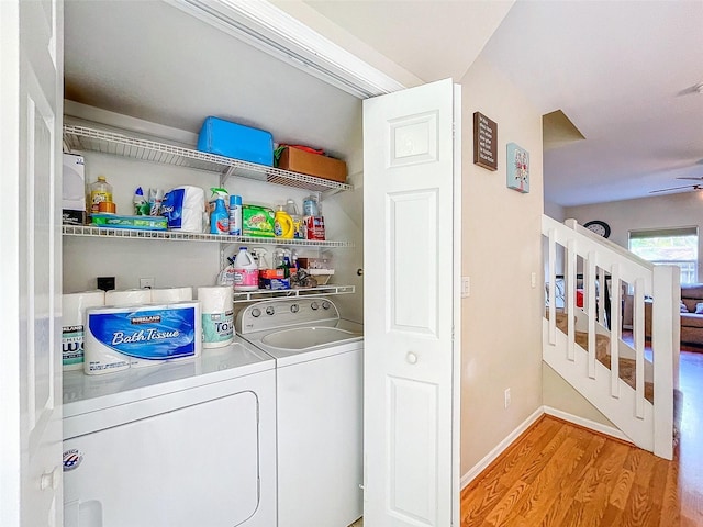 clothes washing area with ceiling fan, washer and clothes dryer, and light hardwood / wood-style floors