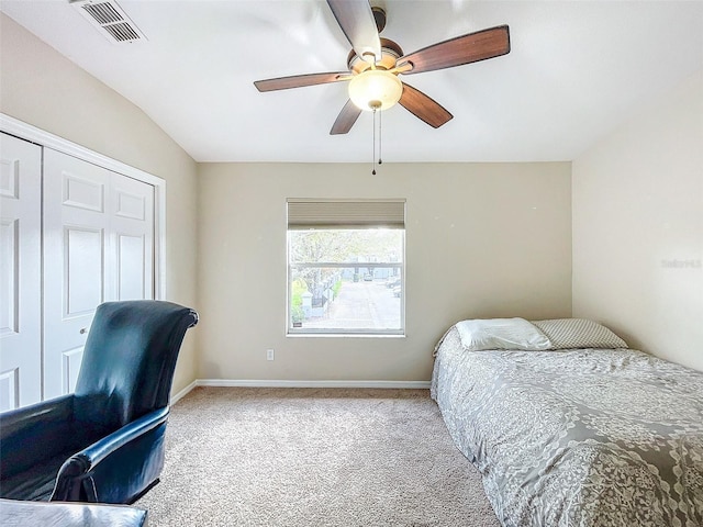 carpeted bedroom featuring ceiling fan and a closet