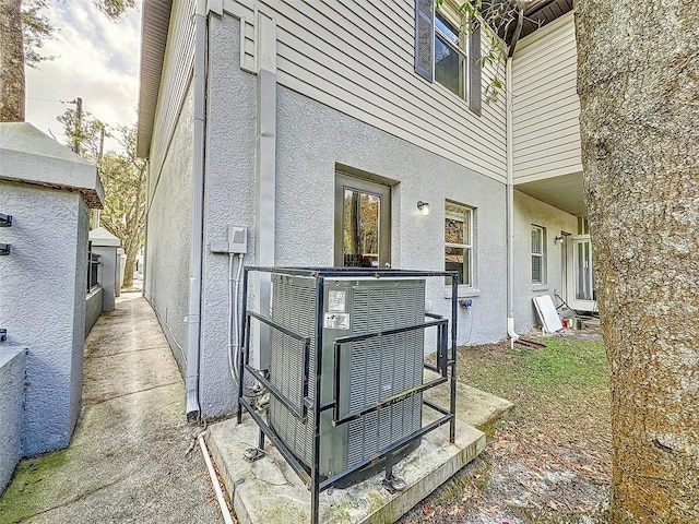 view of side of home featuring central AC