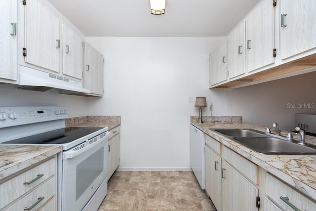 kitchen featuring white appliances, range hood, and sink