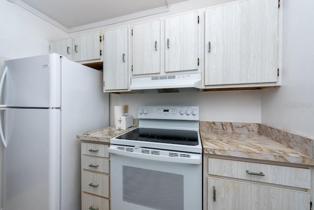 kitchen with light brown cabinetry and white appliances