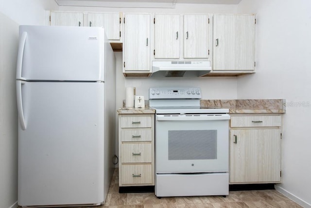 kitchen with light brown cabinets and white appliances