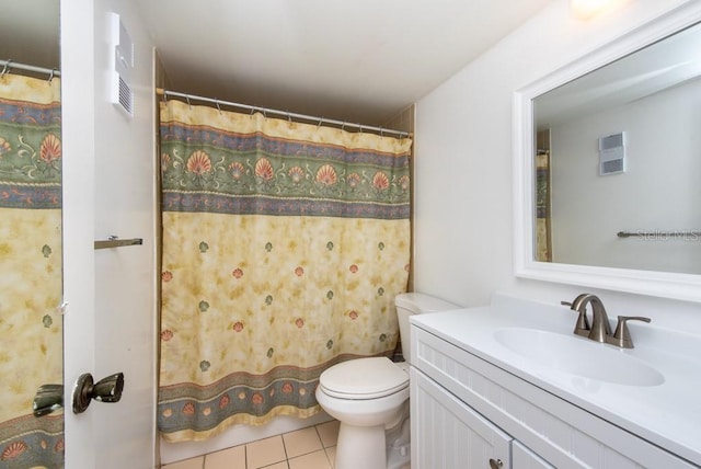 bathroom featuring toilet, vanity, tile patterned floors, and curtained shower