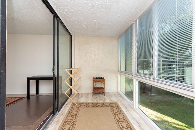 interior space featuring a textured ceiling and hardwood / wood-style flooring