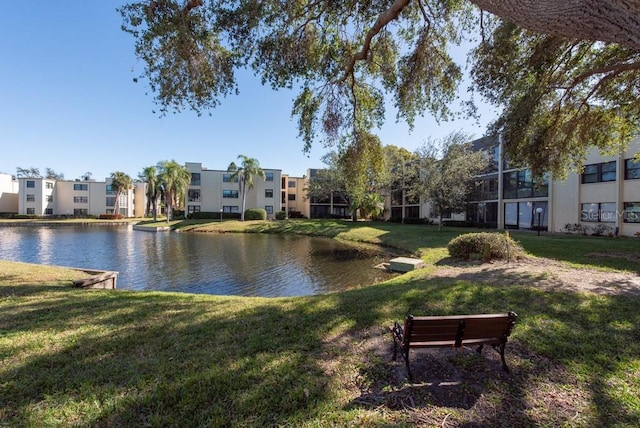 view of community featuring a yard and a water view