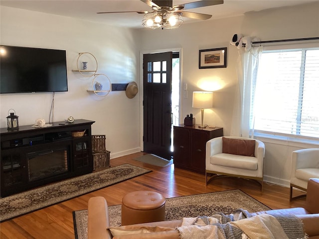 living room featuring ceiling fan and light wood-type flooring