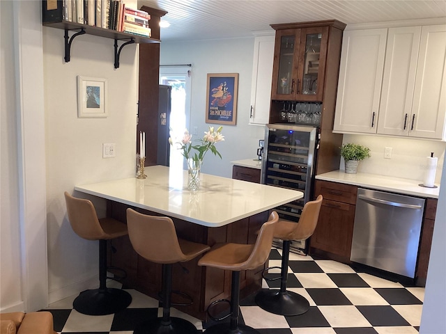 kitchen featuring a breakfast bar area, kitchen peninsula, and dishwasher