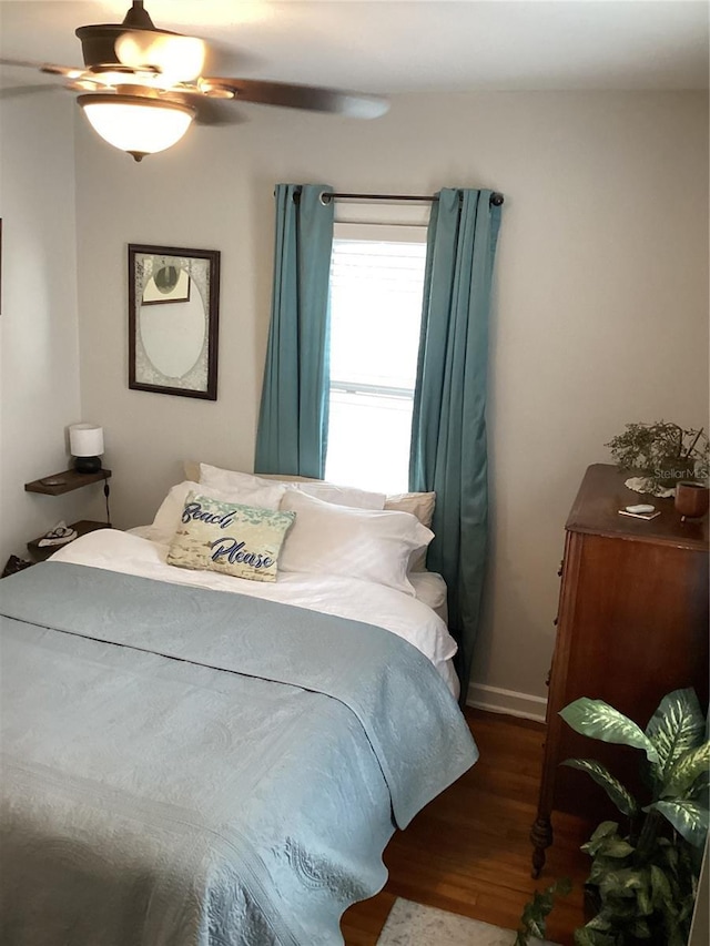 bedroom featuring ceiling fan and dark hardwood / wood-style floors