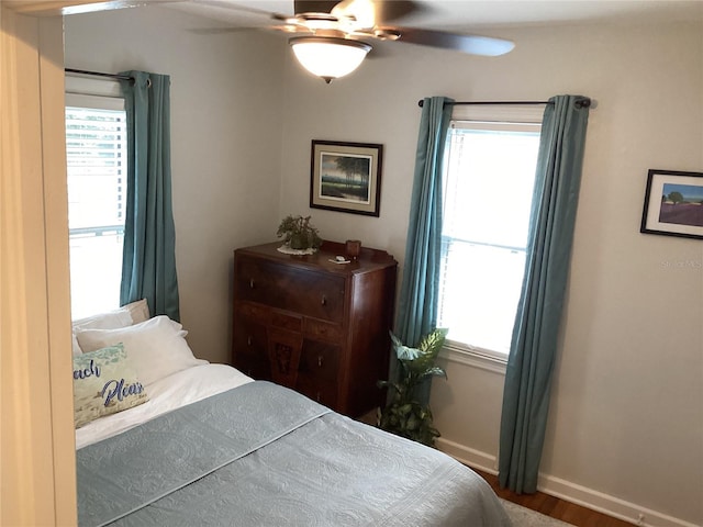 bedroom with hardwood / wood-style floors and ceiling fan