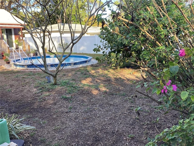 view of yard featuring a fenced in pool