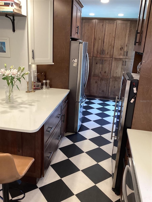 1529 Paloma Ln, Dunedin, FL 34698 - kitchen with light flooring, freestanding refrigerator, light countertops, recessed lighting, and white cabinets