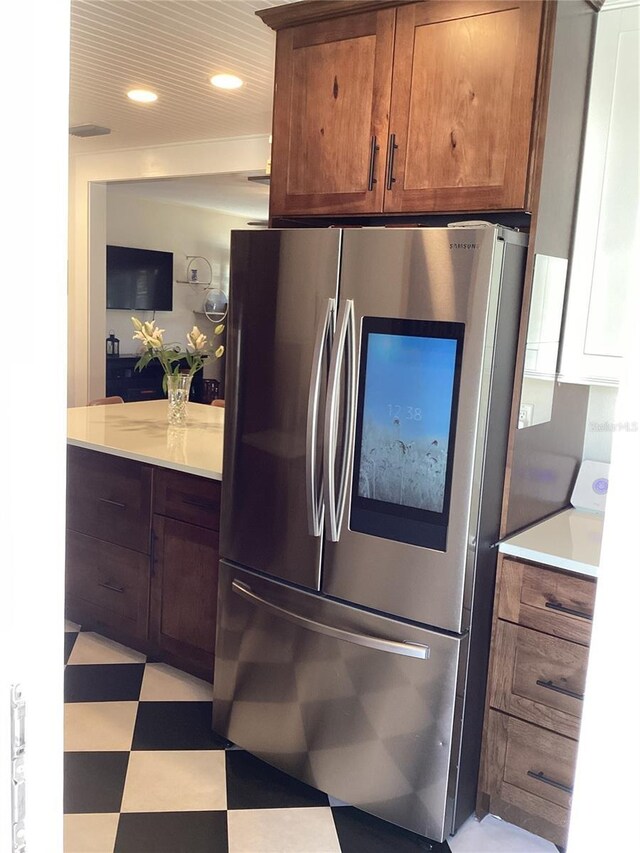 1529 Paloma Ln, Dunedin, FL 34698 - kitchen with smart refrigerator, light floors, light countertops, brown cabinets, and recessed lighting