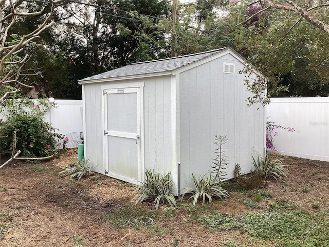 1529 Paloma Ln, Dunedin, FL 34698 - view of shed featuring a fenced backyard and view of wooded area