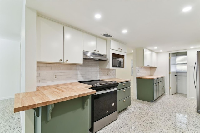 kitchen with appliances with stainless steel finishes, white cabinetry, wood counters, green cabinetry, and under cabinet range hood