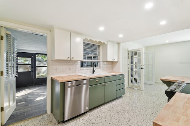 kitchen featuring green cabinetry, stainless steel dishwasher, white cabinetry, a sink, and recessed lighting