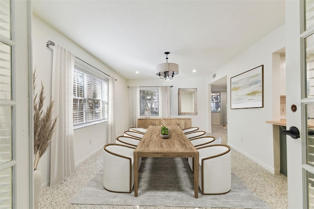 dining space featuring light speckled floor, a notable chandelier, breakfast area, recessed lighting, and baseboards