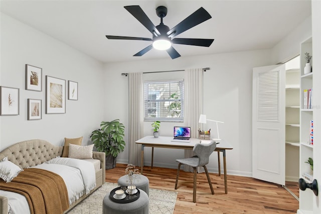 interior space with baseboards, light wood-style flooring, and a ceiling fan